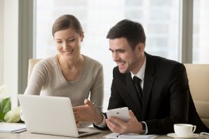 two people looking at laptop